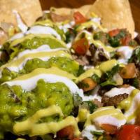 Nachos · Crispy chips, topped with Bronco Beans, melted cheese, jalapeño sauce, pico de gallo, crema,...