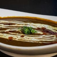 Dal Invitation (House Dal) · Whole black lentil simmered on slow fire overnight & tempered with ginger, garlic & tomatoes.