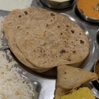 Punjabi Thali · Punjabi sabzi of the day, chole, undhiyu, rice, khadhi,  roti or puri, 2 appetizers, dessert...