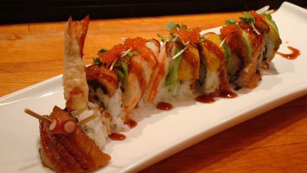 Rainbow Dragon · Shrimp tempura & cucumber
, topped with eel, salmon, and avocado.