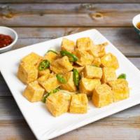 Crispy Tofu with Salt & Chili Peppers · Crispy tofu cooked with chili peppers and garnished with salt.