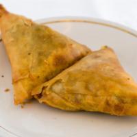 Lamb Samosa · (2) crispy puffs filled with ground lamb, onions and herbs.