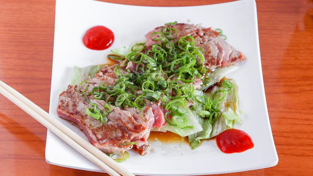 Beef Sashimi · Seared beef slices with special sauce.