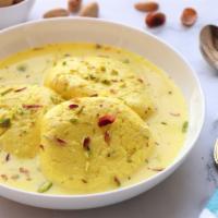 Ras Malai · Paneer discs cooked in simple syrup and soaked in sweetened cream.