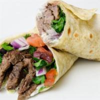 Beef Shawarma Sandwich · Delicious juicy beef wrapped with hummus, tahini, tzatziki, red onion, hot sauce, lettuce, a...