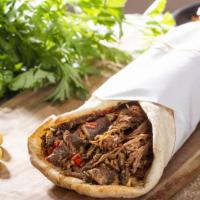 Lamb Shawarma Sandwich · Delicious juicy lamb wrapped with hummus, tahini, tzatziki, red onion, hot sauce, lettuce, a...