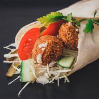 Falafel Shawarma Sandwich · Delicious and fresh falafel wrapped with hummus, tahini, tzatziki, red onion, hot sauce, let...