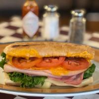 Village Sandwich (hot) · Ham, Turkey, Salami, Swiss and Cheddar Cheeses, Tomato, Lettuces on French Roll.