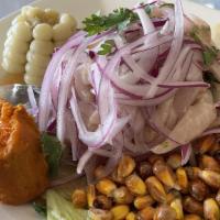 Ceviche de Pescado · Fish marinated in lemon juice with spices and onions.