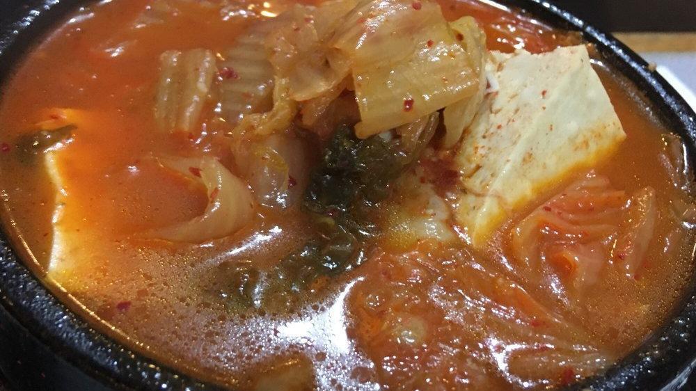 Kimchi Jjigae · Spicy. Pork, kimchi and tofu soup.