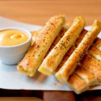 Garlic Bread Sticks · Warm house-made golden garlic breadsticks.