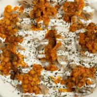 Mantu · Pasta filled with ground beef, onions, garlic and spices topped with a vegetable sauce, garl...