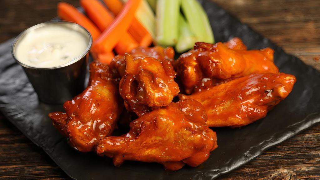 Traditional Classic Buffalo · 8 traditional wings tossed in classic Buffalo Sauce (medium heat), served with carrots & celery and a dipping sauce of your choice.
