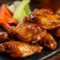 Traditional Hot Honey · 8 traditional wings tossed in hot honey glaze (medium heat), served with carrots & celery an...