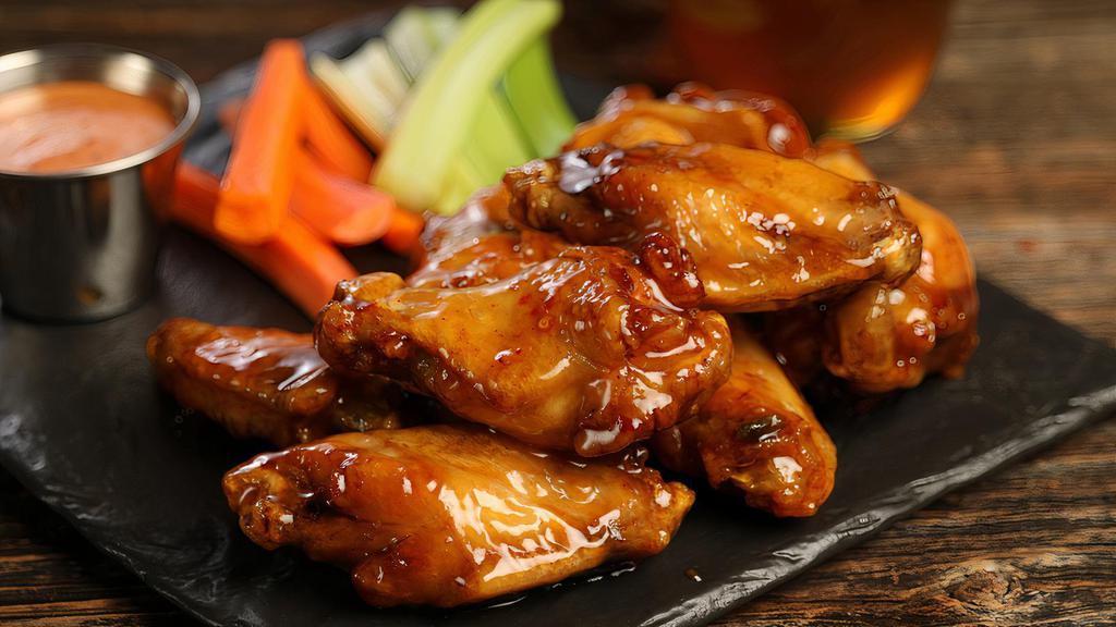 Traditional Hot Honey · 8 traditional wings tossed in hot honey glaze (medium heat), served with carrots & celery and a dipping sauce of your choice.