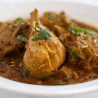 Achar Chicken · Chicken in tomato base sauce, slightly tangy and spicy blend of spices.