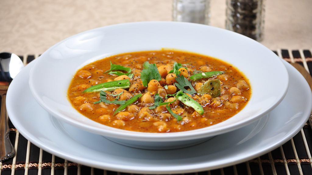 Chana Masala · Vegan. Garbanzo beans cooked with ginger, garlic & spices.