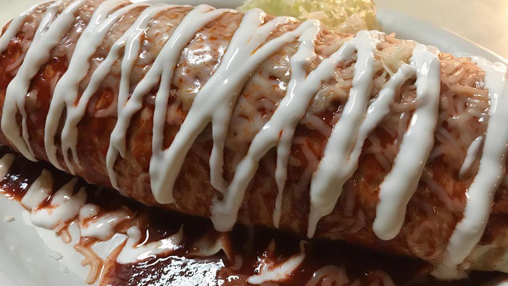 Super Burrito Enchilado (Super Wet Burrito) · Choice of meat, rice, beans, pico de gallo, sour cream, cheese and guacamole. Topped with enchilada sauce, melted cheese and sour cream.