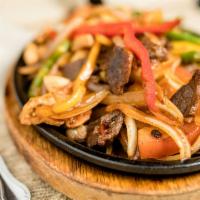 Fajitas · Choice of meat sauteed with bell pepper, onion, and tomato. Served with rice, beans, pico de...
