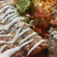 Enchiladas · Two enchiladas stuffed with cheese or choice of meat. Served with rice, beans, sour cream, l...