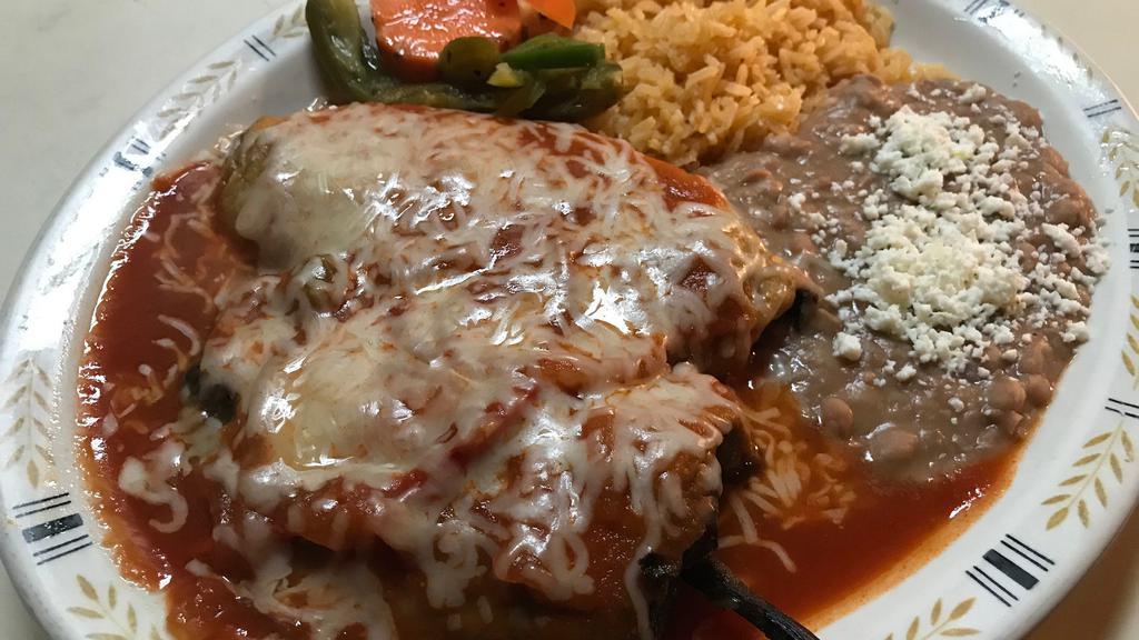 Chiles Rellenos · Vegetarian. Two toasted poblano peppers, stuffed with cheese, and topped with ranchera sauce. Served with rice and beans.