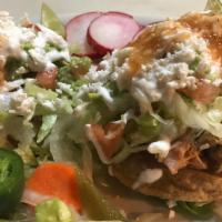Sopes · Two home-made corn patties topped with beans, choice of meat, lettuce, sour cream, cheese an...