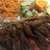 Deep Fried Whole Fish · Topped with choice of sauce. Served with rice, beans, salad, and tortillas.