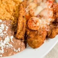 Filete Empanizado con Camarones · Breaded fish filet topped with ranchera sauce, melted jack cheese, and grilled shrimp. Serve...