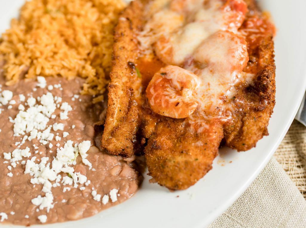 Filete Empanizado con Camarones · Breaded fish filet topped with ranchera sauce, melted jack cheese, and grilled shrimp. Served with rice, beans, salad, and tortillas.