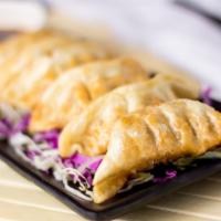 Gyoza - Japanese Pot Stickers · Pork, chicken or veggie crispy fried pot stickers. Served with sweet and spicy soy vinaigret...