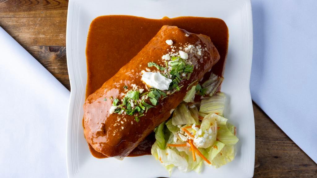 Burrito Mojado Gourmet · Burrito Drenched in mole sauce or green sauce and melted cheese with your choice of meat ( carnitas, steak,chicken, al pastor and veg­ gies) ingredientsinclude rice,beans, onions,picode gallo,sourcream, cheese, guacamole andsalsa