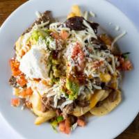 Steak Fries · French fries t opped with your choice of steak, chicken or carnitas, rice, beans, meat, home...