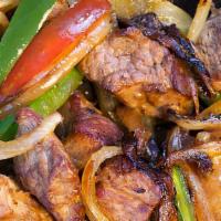 Zilzil Tibs · Strips of tender beef sautéed with onions and jalapeños.