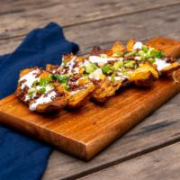 * Potato Skins · Scooped out skins, fried to a crisp and then topped with cheddar cheese, bacon, green onions...