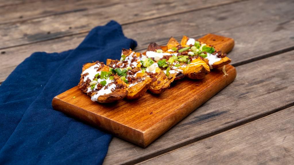 * Potato Skins · Scooped out skins, fried to a crisp and then topped with cheddar cheese, bacon, green onions and sour cream