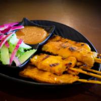 4. Chicken Satay · Marinated and charcoal broiled chicken skewers, served with side of cucumber salad and peanu...