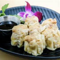Steamed Dumplings (shumai) · Steamed ground pork and shrimp with onions, carrots, wrapped in wonton skin served with a so...
