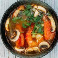 14. Tom Yum Soup · Spicy and sour shrimp soup with mushroom, tomatoes, and lemon grass.