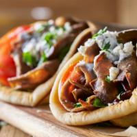 Gyro Sandwich · Delicious gyro meat with onions, tomatoes and cucumber sauce.