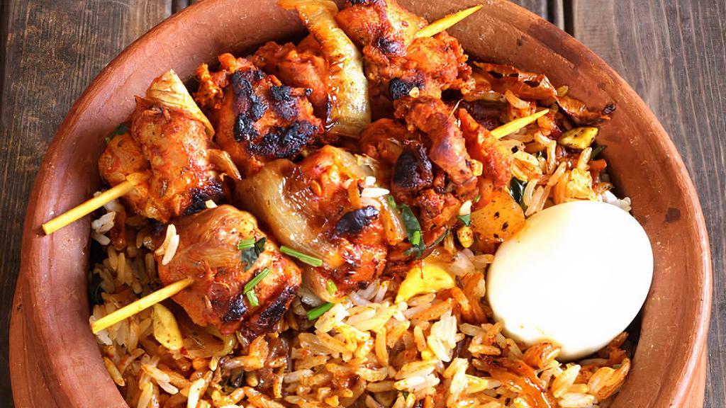 Chicken Tikka Biryani · White meat (chicken breast) cooked traditionally with flavored basmati rice, special biryani masala, yogurt, and a variety of spices garnished with egg, onion, and lemon.