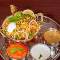 Chicken Dum Biryani · Long grain basmati rice flavored with saffron and cooked with chicken and herbs. Served with...