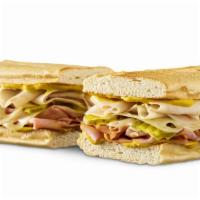 Cubano  · Oven Roasted Turkey, Ham, & Melted Swiss Cheese with Pickles & Yellow Mustard on Toasted & P...
