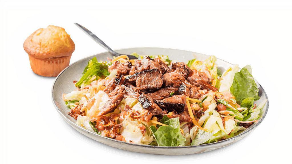 Dave'S Sassy Barbeque Salad · Choice of Georgia Chopped Pork, Texas Beef Brisket or Chicken (BBQ pulled, grilled or crispy). Served on crisp greens with bacon, house-smoked cheddar cheese, tomatoes and shoestring potatoes. Tossed with honey BBQ dressing. . Served with a Corn Bread Muffin