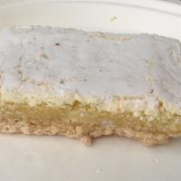 Lemon Bar · A shortbread crust topped with sweet, tangy lemon filling lightly dusted with powdered sugar.