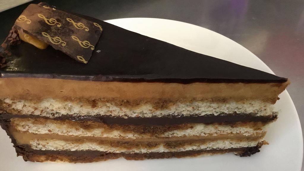 Opera Cake · Two layers of coffee mousses and two layers of chocolate ganache. Decorated with chocolate mirror and chocolate piece with gold stencil.