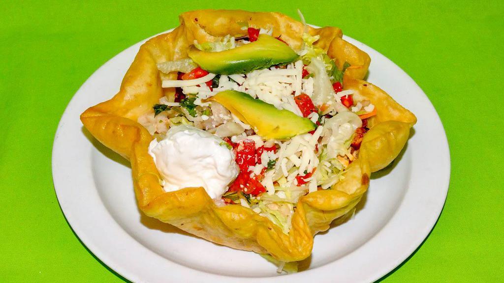 Taco Salad · Deep fried shell flour tortilla filled with meat, rice, beans, Lettuce, sour cream, pico de gallo and cheese.