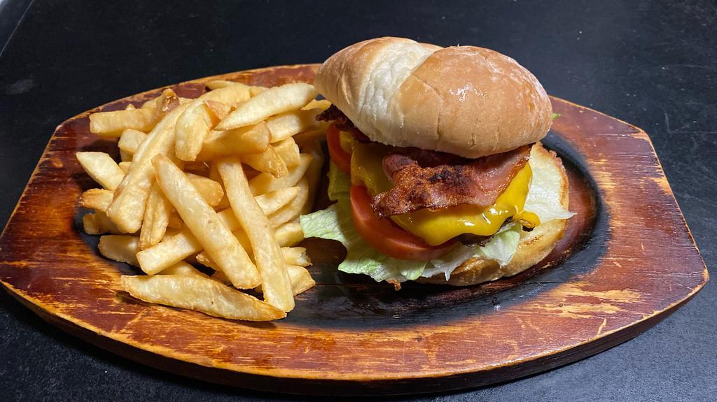 The Golden Burger · Meat, Cheddar Cheese, Bacon, Lettuce, Tomato, Pickle.