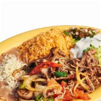 Bistec Ranchero Plate · Steak cooked with onions, tomatoes, and jalapenos. Includes rice, beans, lettuce, guacamole,...