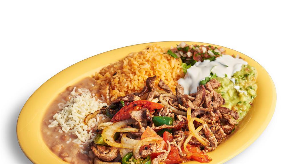 Bistec Ranchero Plate · Steak cooked with onions, tomatoes, and jalapenos. Includes rice, beans, lettuce, guacamole, salsa, sour cream, cheese, and tortillas.