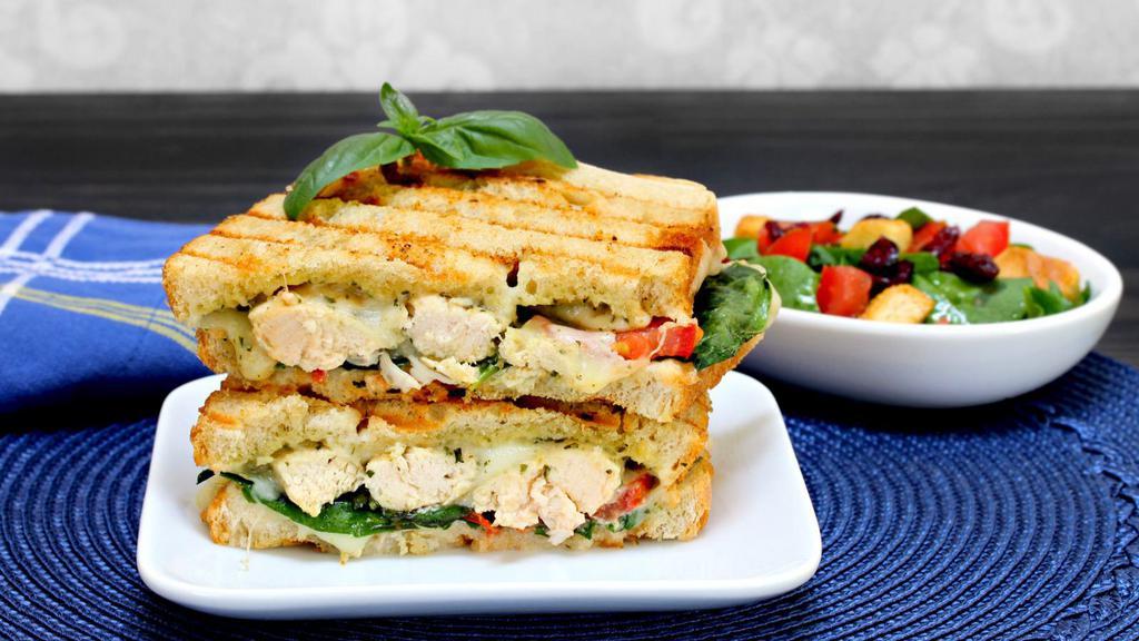 Chicken Pesto Panini · Hot off the panini press! Comes with grilled chicken breast, pesto sauce, roasted mushrooms, house-grilled onions, and provolne cheese.